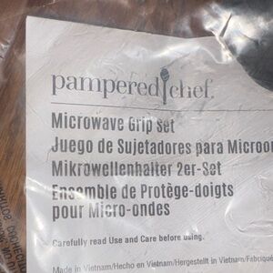 Pampered Chef Black Microwave Grip 
Set of 2, original, unopened packaging.